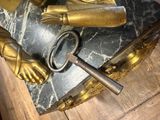 a statue of a person holding a key on top of a table