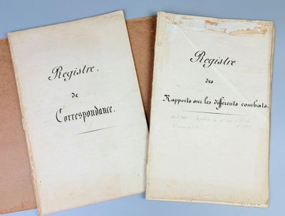 two old papers with writing on them sitting on top of a table