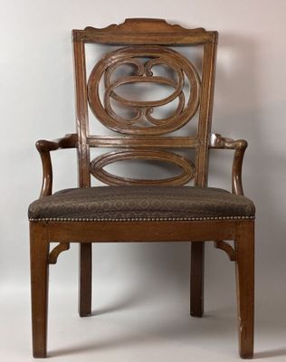 a wooden chair with a brown upholstered seat
