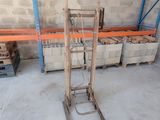 a small hand truck that is sitting in a warehouse