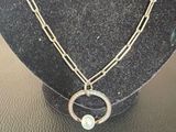 a close up of a necklace on a mannequin with a chain