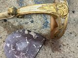 a gold handle on a marble block on the ground