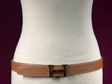 brown leather belt on mannequin torso with red background