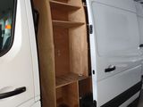 a white van with a wooden shelf in the back