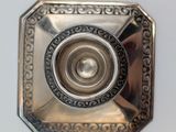 an antique silver plate with a circular design on it