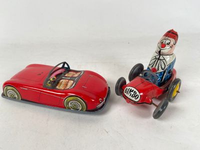 pair of tin toys of clown driving a red car and a clown in a red car