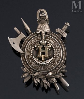 an image of a metal badge with two knives and a crown