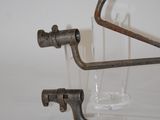 two metal pipes that are connected to a glass holder