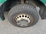 a close up of a tire on a green truck