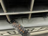 the front bumper of a car with a ruler attached to it