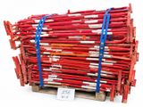 a pile of red sticks on a pallet with a price tag