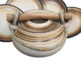 a brown and white pot with a wooden handle on it