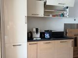 a kitchen with a stove, refrigerator, microwave, and a refrigerator freezer