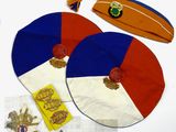 two hats, a surfboard, a hat, and other items laid out on a table