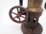 an old fashioned coffee grinder sitting on a white surface
