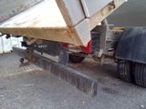 a dump truck that is parked on the side of the road
