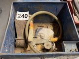 a blue box with a hose in it sitting on a table
