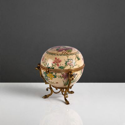 a small decorative box on a stand on a table