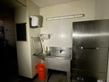 a kitchen with a sink and a refrigerator in it
