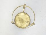 a gold plated clock with a circular design on it