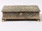 an old wooden box with a decorative design on the lid