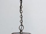 a hanging light that is hanging from a chain