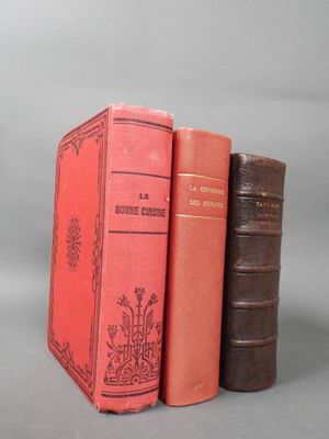 three books sitting on top of each other on a gray surface