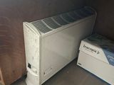 a small air conditioner sitting next to a box on the floor