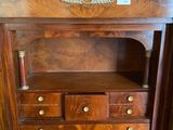 a wooden cabinet with drawers and a marble top