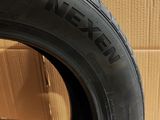 a close up of a tire on a cardboard box with a cardboard box in the background