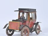 a small toy car with a man sitting in it