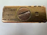 the gold bar is being held up by a hand