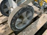 a close up of a wheel on a wooden pallet