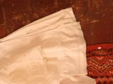a picture of a pair of white pants laying on a red rug