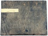 an old book with a white cross on it sitting on top of a table