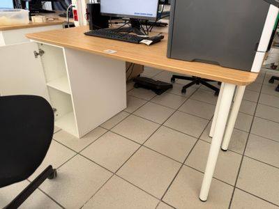 a desk with a computer monitor and a keyboard on it