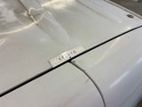 a sticker on the hood of a white car