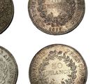 four different types of silver coins on a white background