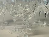 six wine glasses lined up on a table