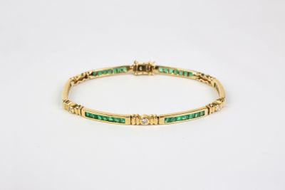 a yellow gold bracelet with emerald stones