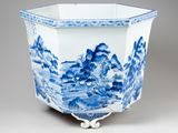 blue and white porcelain planter with a landscape design
