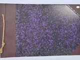 a purple and black book with a rope on it
