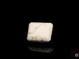 a picture of a white marble block on a black surface