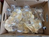 a box full of empty wine glasses and spoons