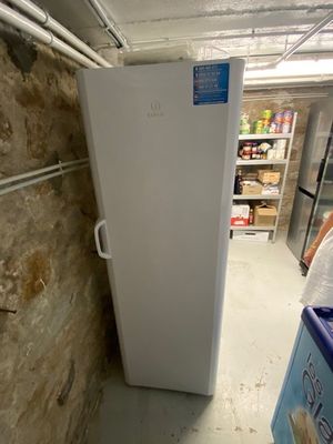an image of a refrigerator in a room with a brick wall