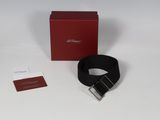 the black belt is next to a red box and a white tag