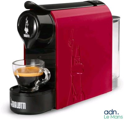 a close up of a coffee machine with a cup of coffee