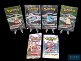 quatre paquets de cartes à collectionner Pokémon empilés les uns sur les autres