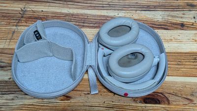 a pair of headphones in a case on a wooden table