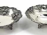 pair of antique silver plated dishes on stands on a white background